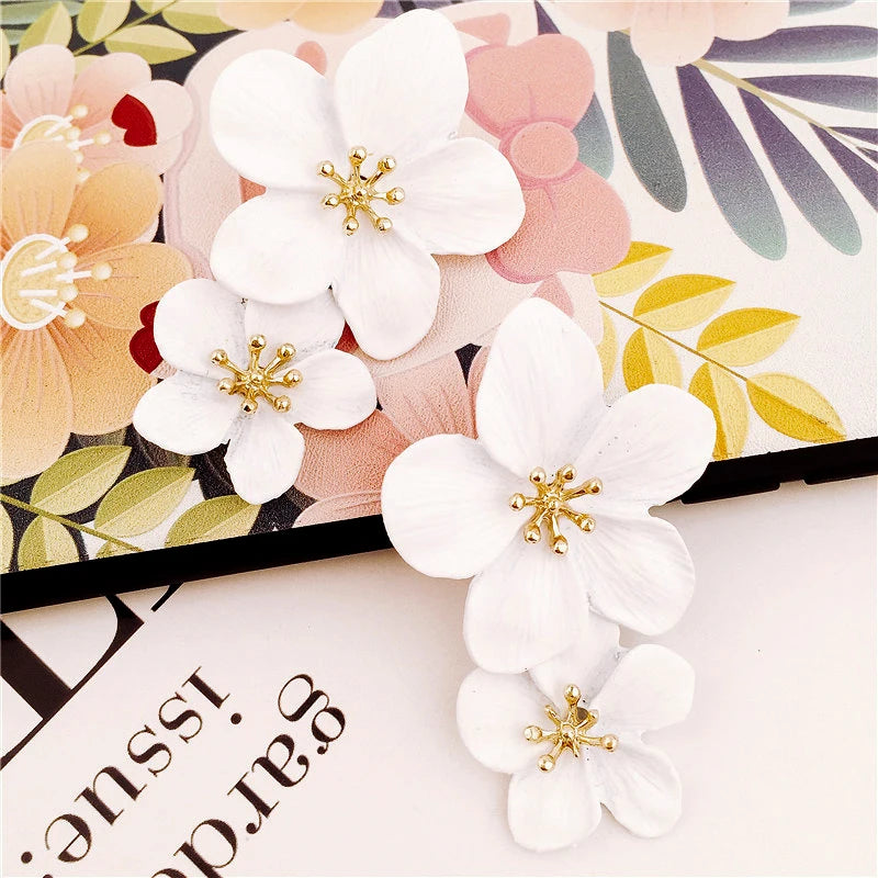 White double-layer flower earrings with gold-tone centers, two-layer petal design