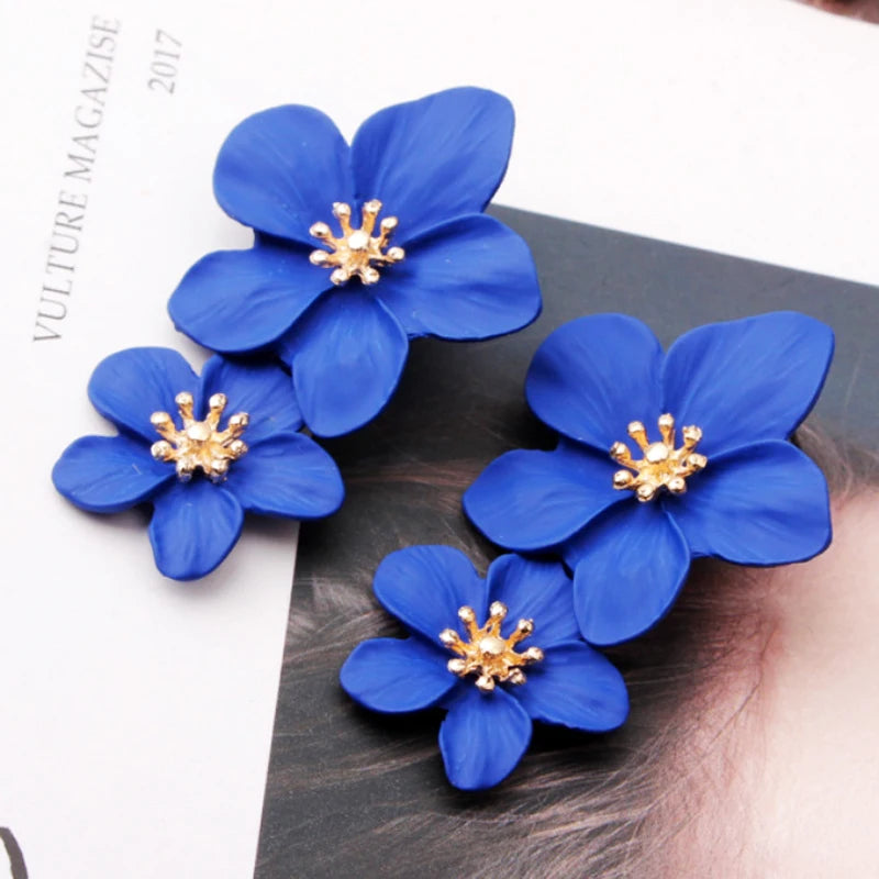 Blue double-layer flower dangle earrings with gold-tone centers, two stacked petals