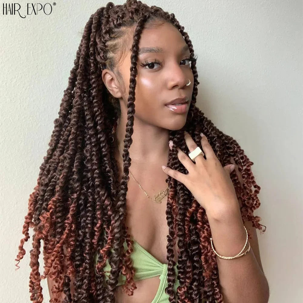 Crochet hair extensions worn, long dark burgundy twist curls framing the face