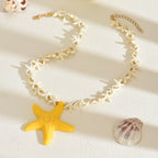 Starfish pendant necklace with white star-link chain and yellow starfish pendant