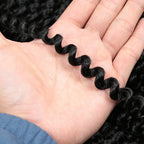 Crochet hair extension strand with tight curls in dark black, shown in a hand.