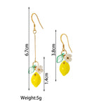 Lemon drop earrings diagram with yellow lemon charm, green leaf, and white flower