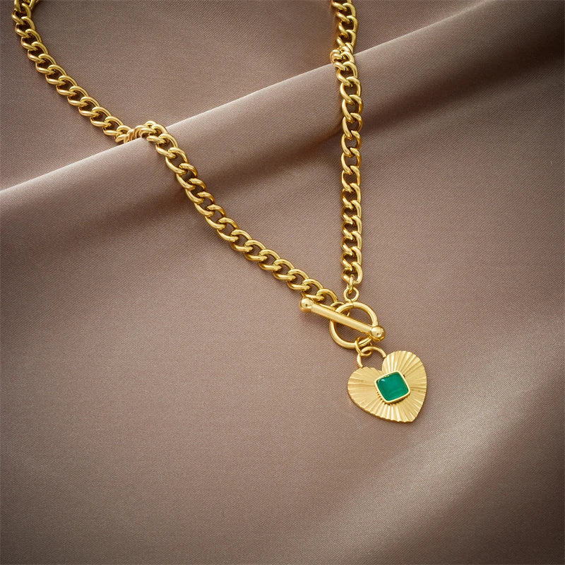 Gold-tone chain necklace with green square stone heart pendant and round toggle clasp