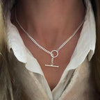 Layered silver-tone chain necklace with Cuban link and paperclip links, ring and bar charm