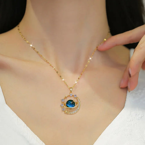 Gold-tone zircon planet pendant necklace with blue circular gemstone and star accents