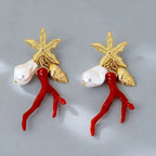 Star-and-figure resin earrings, red resin dancers and white pearls with gold-tone details