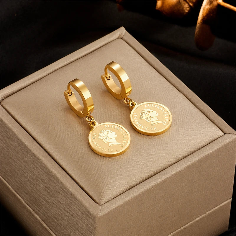 Gold-tone hoop earrings with round coin-style dangle charms