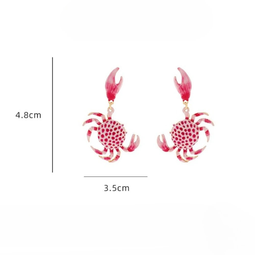 Crab drop earrings with red-and-white dotted bodies, pink claws, and gold hooks