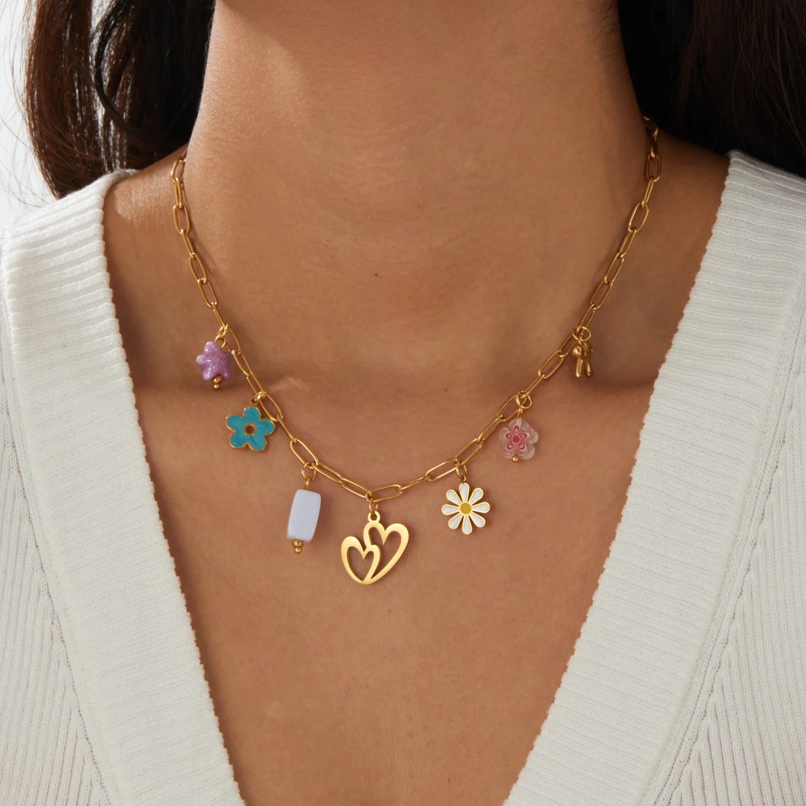 Gold enamel pendant necklace with heart, white block, and colorful flower charms