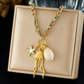 Jellyfish charm pendant necklace on blue and gold chain, white shell drop