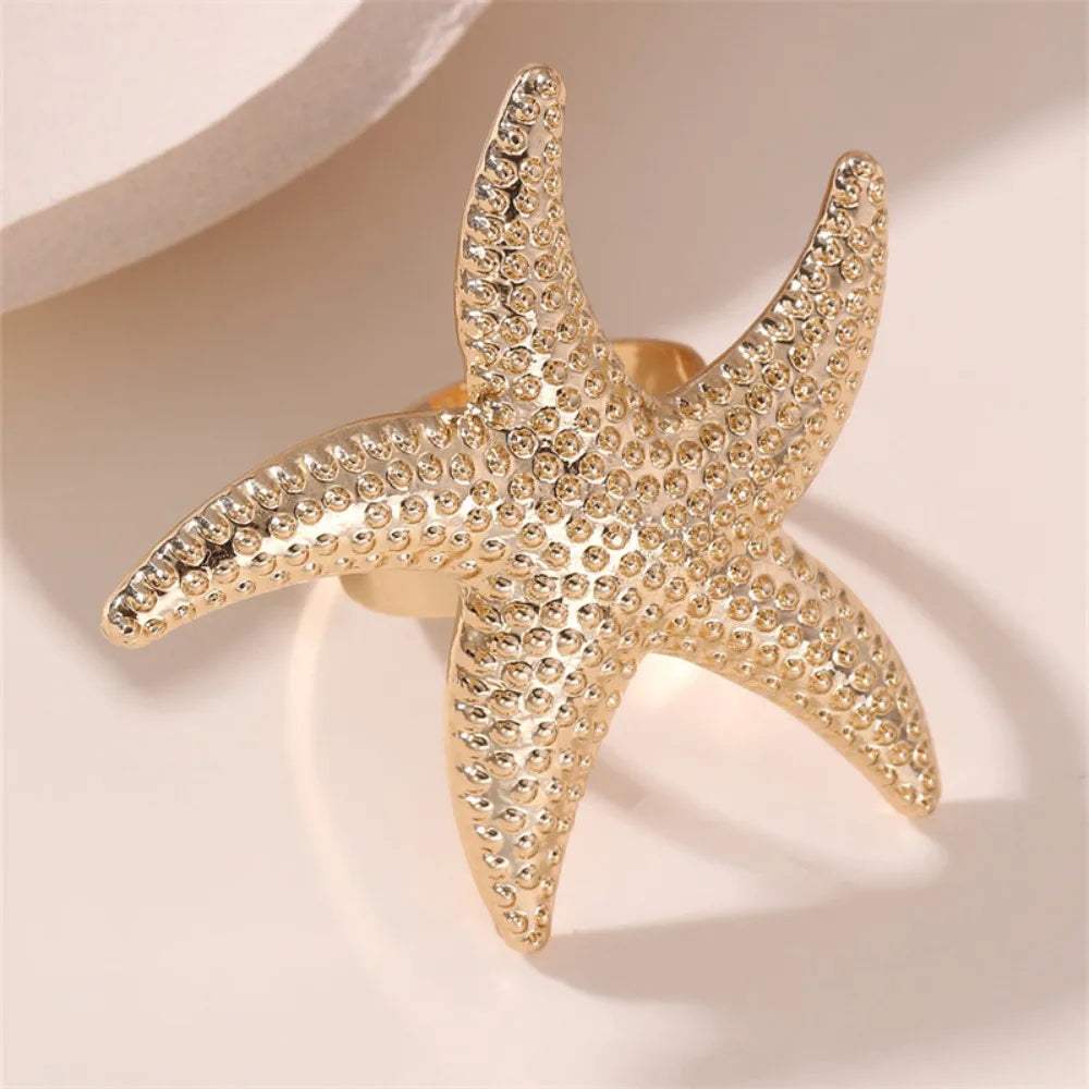 Gold-tone starfish ring, rhinestone-studded starfish design