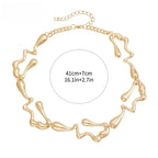 Gold-tone lava-drop choker necklace with chain links and abstract pendant shapes