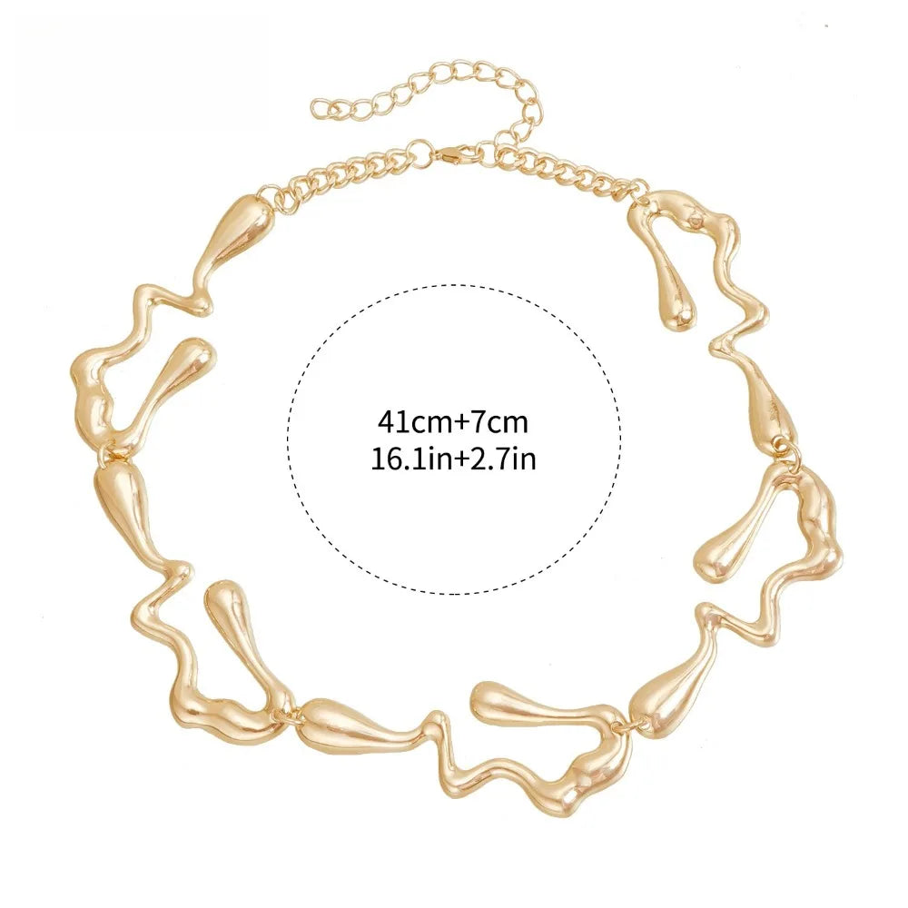 Gold-tone lava-drop choker necklace with chain links and abstract pendant shapes