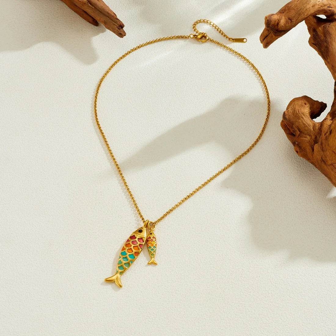 Ocean fish pendant necklace with two multicolor enamel fish charms on gold chain