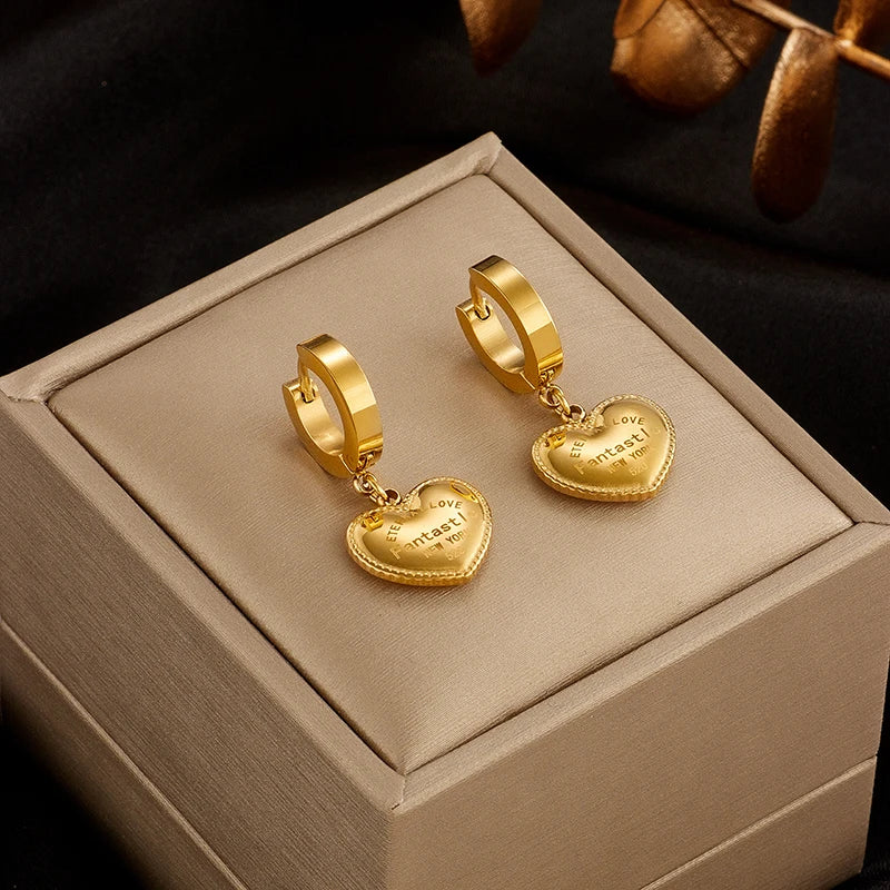 Gold-tone hoop earrings with heart coin dangle charms
