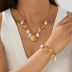 Gold-tone ocean charm necklace with pearls and crab, turtle & shell pendants