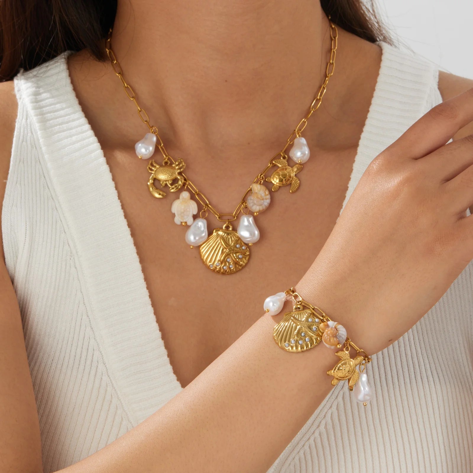 Gold-tone ocean charm necklace with pearls and crab, turtle & shell pendants