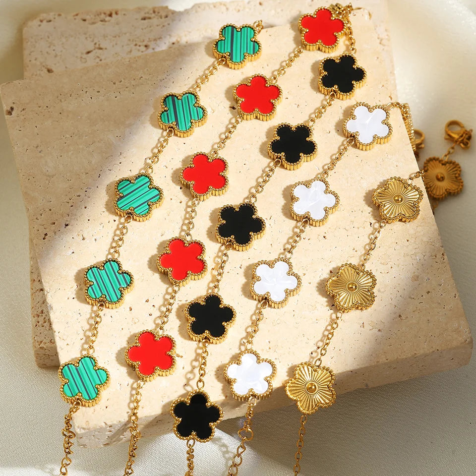 Multicolor clover jewelry set with gold-tone necklace, bracelet, and stud earrings