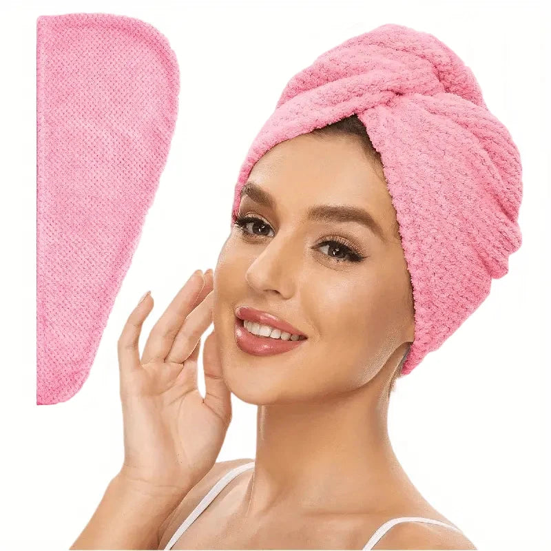 Pink absorbent hair towel wrap on head with rolled turban and side hanging tail