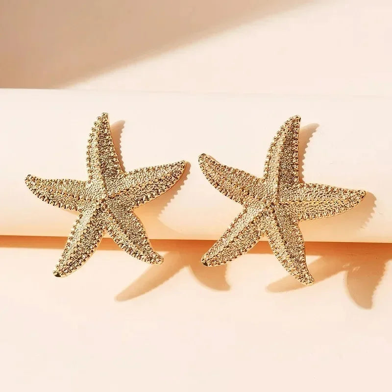 Boucles d'oreilles pendantes bohème à pompons — Étoile de mer et coquillage
