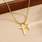 Gold cross pendant necklace with double cross charm on a beaded chain