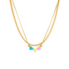 Gold double-chain necklace with blue, pink, and cream enamel heart charms