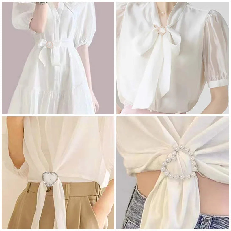 Scarf tie brooch clip with pearl accents fastening a white blouse neck bow