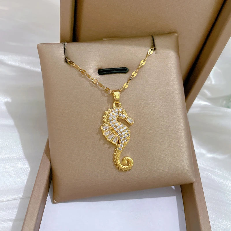 Gold-tone seahorse rhinestone pendant necklace on display card