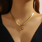 Gold-tone snake chain necklace with rose flower pendant and red heart charm