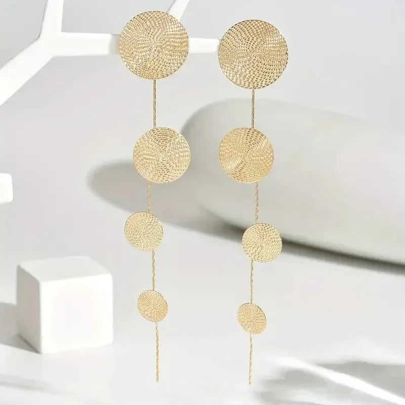 Gold-tone disc dangle earrings, four woven circles with thin chain tassel