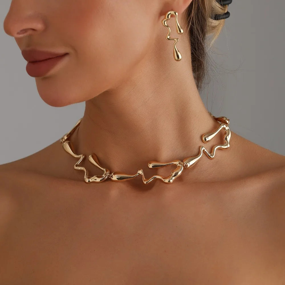Gold-tone lava-drop choker necklace with irregular links and drop earrings