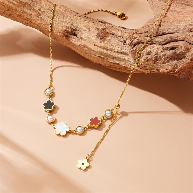 Gold-tone five-petal flower pearl necklace with dangling charm and pearl bead links