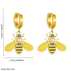 Gold-tone hoop earrings with dangling bee charms and central pearl