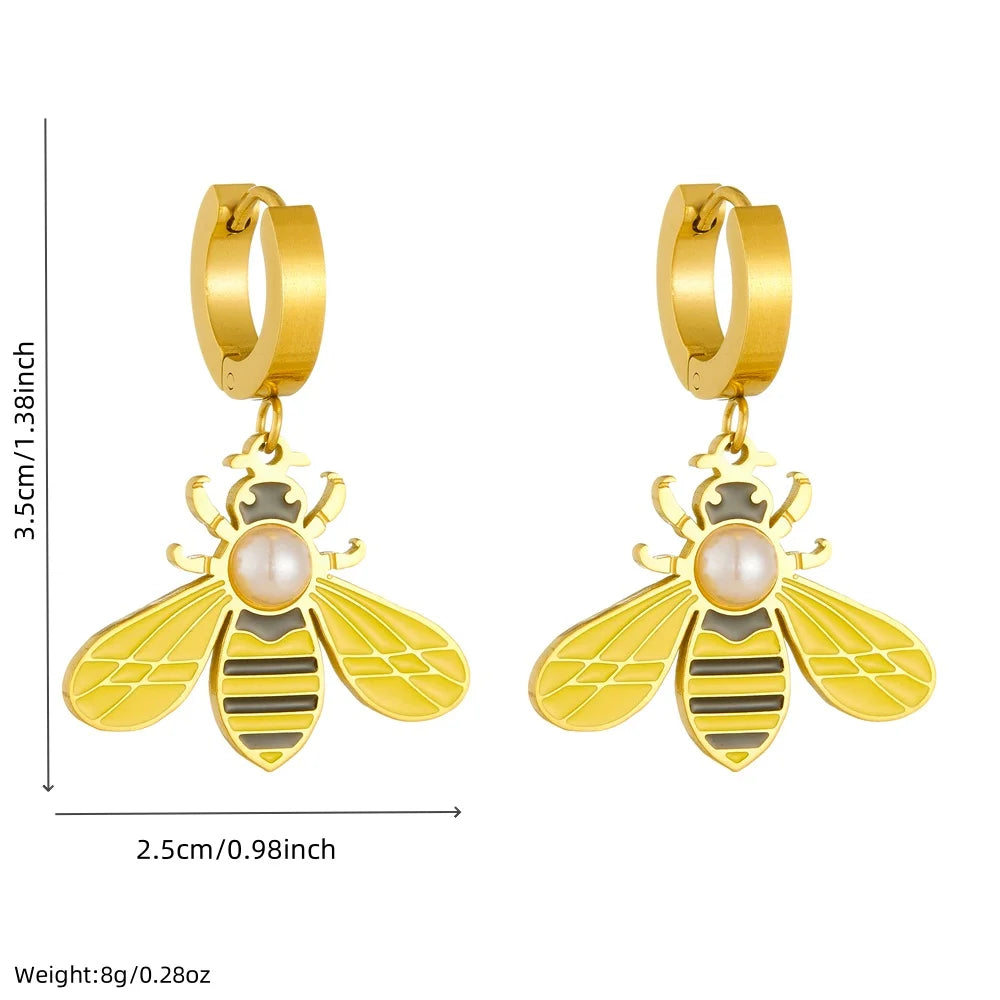 Gold-tone hoop earrings with dangling bee charms and central pearl