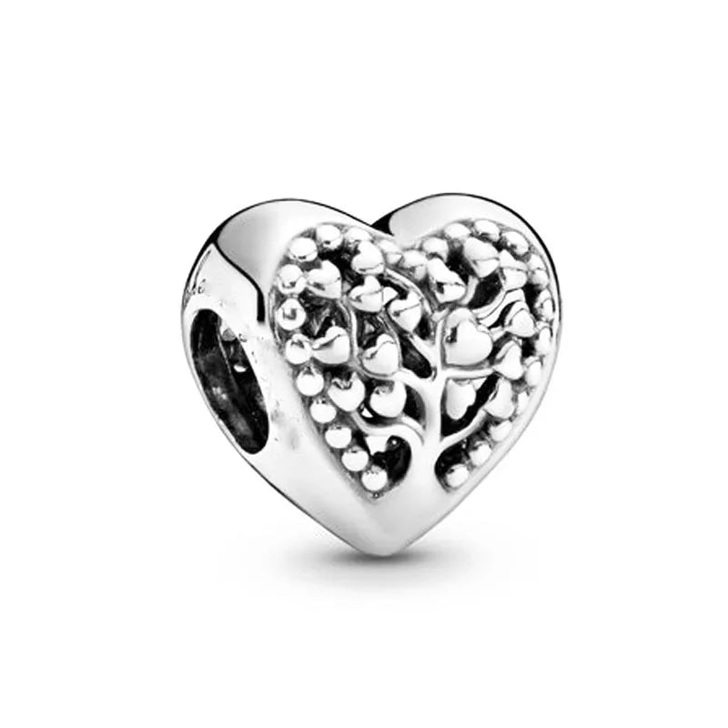 Silver-tone heart charm bead with raised filigree and small round stone accents