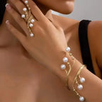 Gold-tone pearl beaded bracelet with curved links and white pearl drops