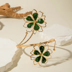 Gold flower upper arm bracelet with dark green stone petals and thin chain band