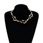 Gold-tone lava drip choker necklace on dark bust