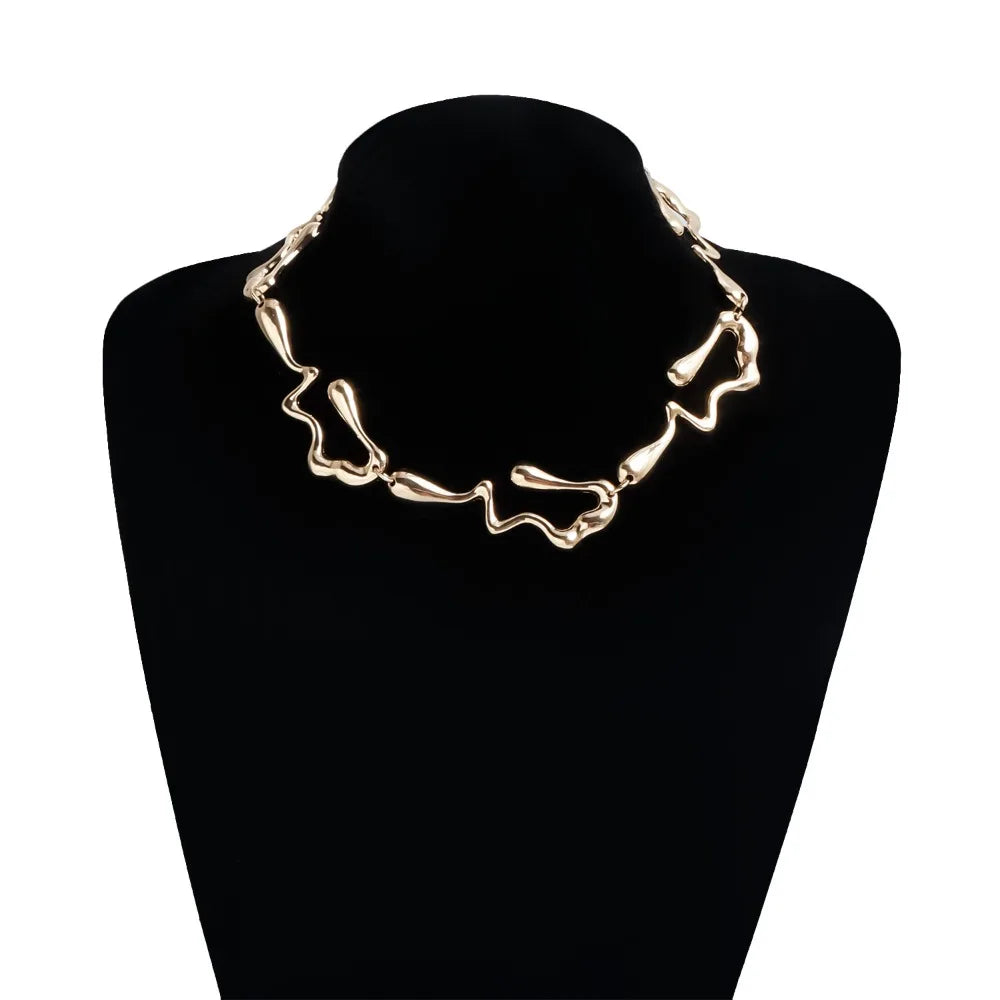 Gold-tone lava drip choker necklace on dark bust