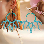 Turquoise acrylic drop earrings with beaded hoops and draping fringe drops