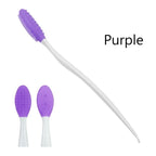 Silicone face cleansing brush with purple oval head and white handle