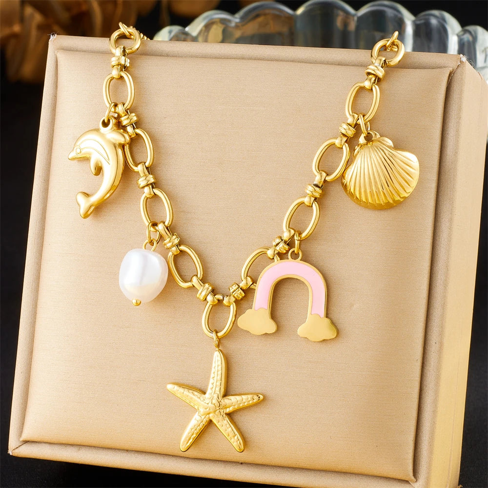 Gold-tone multi-pendant necklace with dolphin, pearl, starfish and shell and cloud charms