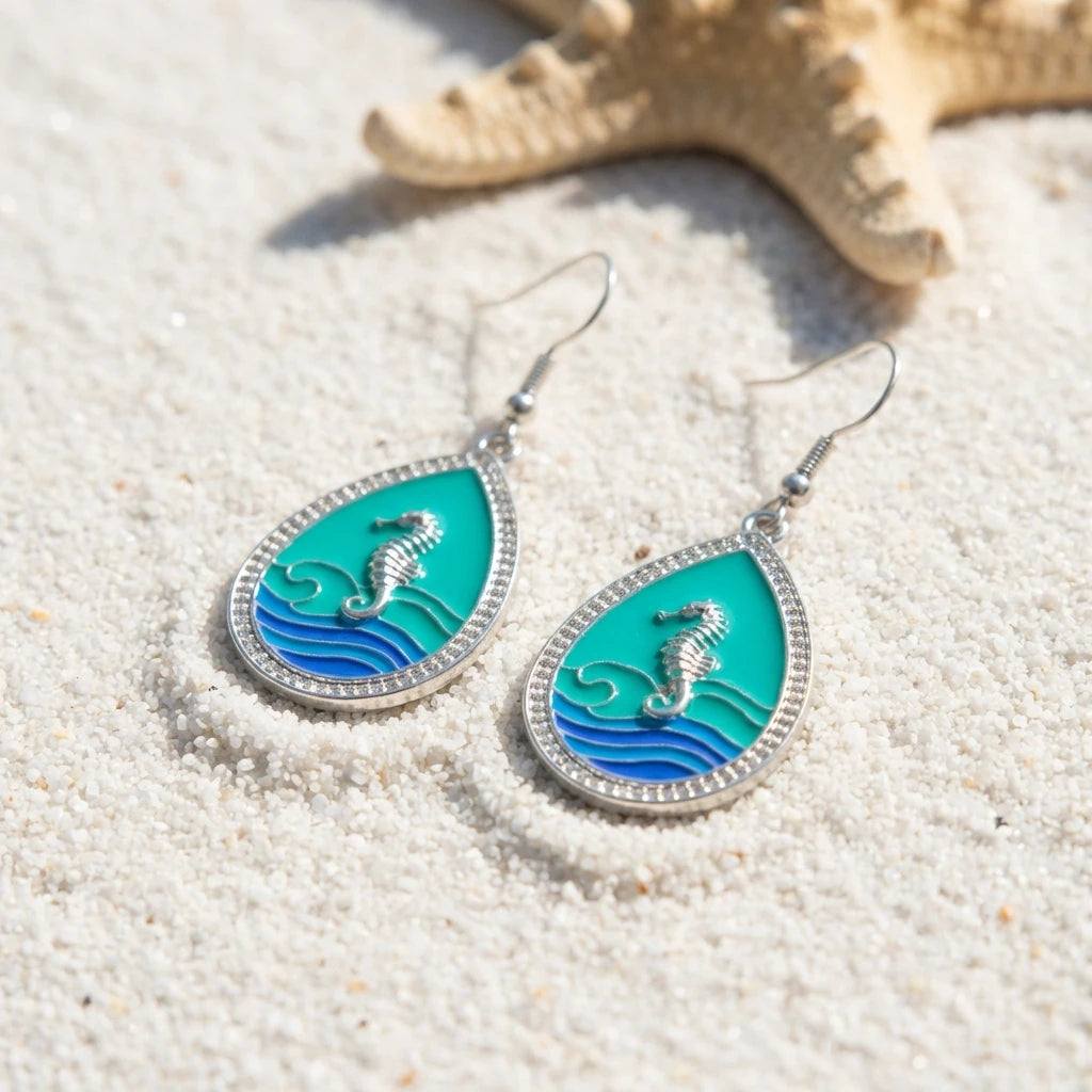 Pair of teardrop seahorse shell earrings in green and blue enamel with silver-tone border