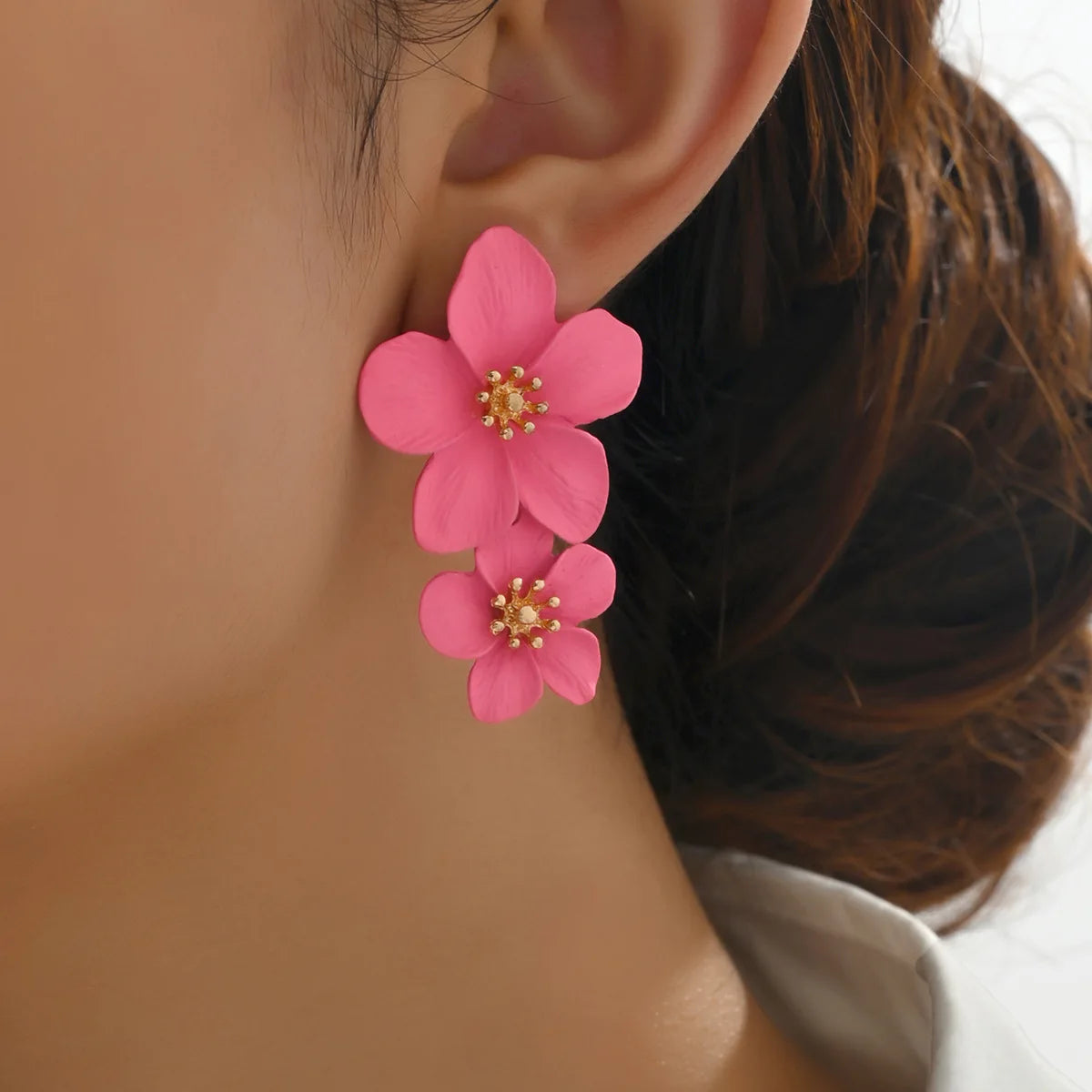 Pink double-layer flower dangle earrings with gold-tone centers, two stacked petals