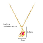 Gold-tone crab pendant necklace with pink center gemstone and sparkling red/clear accents.