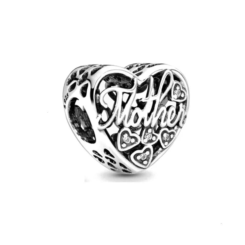 Silver heart charm bead with “Mom” script, cutout hearts, and engraved decorative border