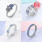Sterling silver evil eye ring set with blue eye motifs, hearts, and openwork bands