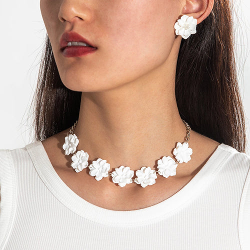 White flower necklace with matching earrings; silver-tone chain with clustered blooms