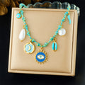Turquoise beaded pendant necklace with sun-eye charm, moon disk, and pearl drops