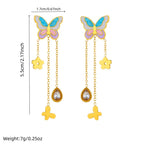 Butterfly drop tassel earrings with blue enamel wings and gold flower plus teardrop charms